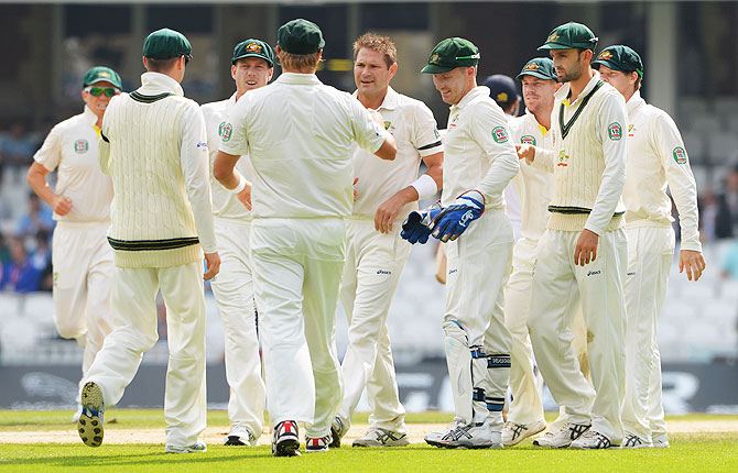 Ryan Harris celebrates with team mates after claiming the wicket of Chris Woakes on Sunday