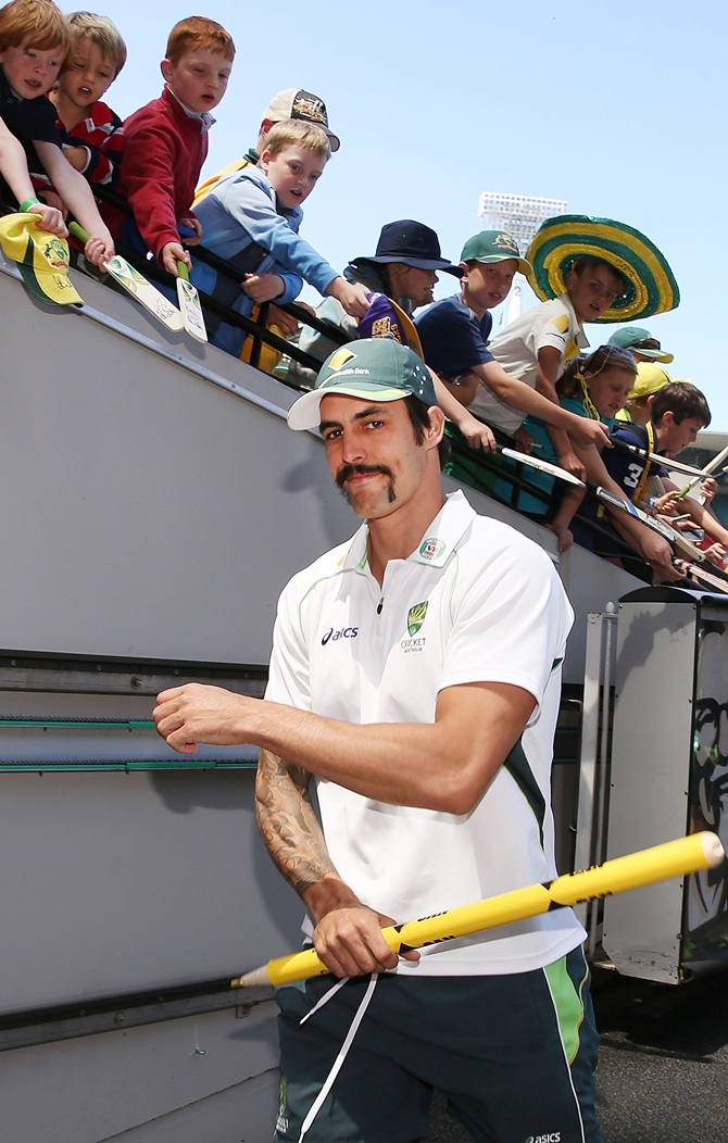 Mitchell Johnson of Australia walks to the change rooms with a stump after victory