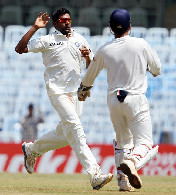 Ravichandran Ashwin celebrates with captain Dhoni after taking the wicket of Shane Watson