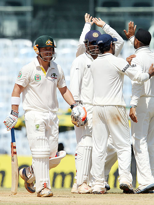 David Warner walks off the field after his dismissal as the Indian team celebrates