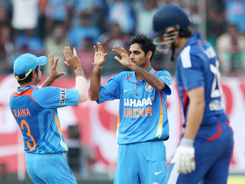 Bhuvneshwar Kumar celebrates after bagging the wicket of Alastair Cook