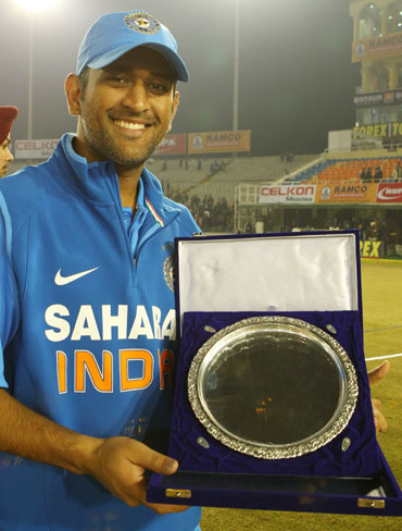 MS Dhoni poses with the match plate after the 4th ODI between India and England at the PCA Stadium, Mohali