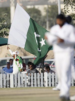 A Pakistan fan waves a flag during a cricket match