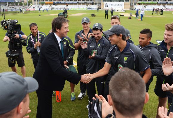 Ashton Agar of Australia receives his Baggy Green cap on his Test debut from former Australian fast bowler Glenn McGrath