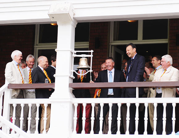Australian selector Rod Marsh (centre) rings the bell prior to start of day three at Lord's