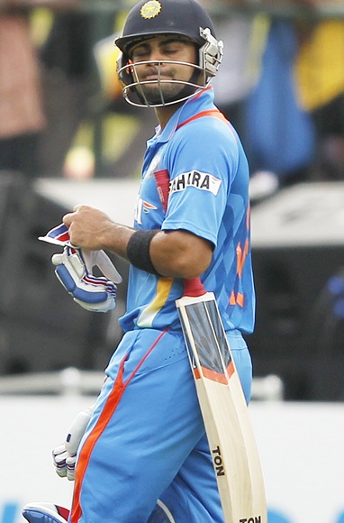 India's captain Virat Kohli reacts as he walks off the field after his dismissal