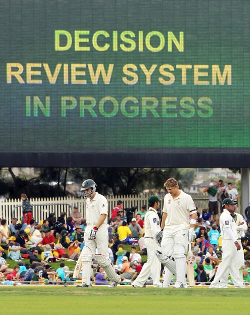 Players wait for the decision review system