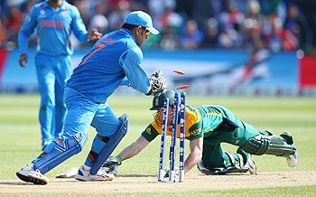 Champions Trophy: AB de Villiers of South Africa narrowly makes his ground as MS Dhoni of India breaks the wickets during their opening match in Cardiff