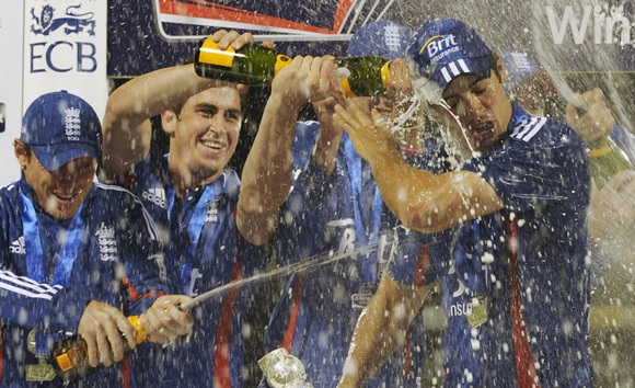 England's captain Alastair Cook has champagne poured on him