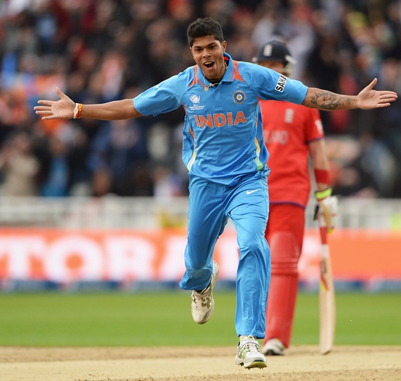 Umesh Yadav of India celebrates the wicket of Alastair Cook