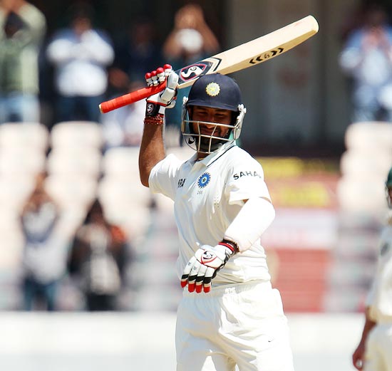 Cheteshwar Pujara celebrates after completing his double century