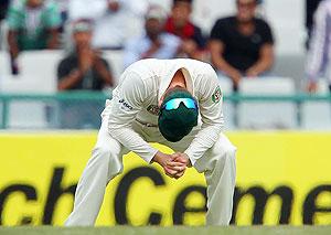 Michael Clarke Captain of Australia looks to the ground after Shikhar Dhawan of India edges one to the boundary