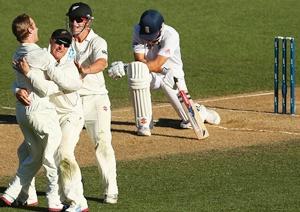 Kane Williamson, Brendon McCullum and Hamish Rutherford of New Zealand celebrate the wicket of Alastair Cook