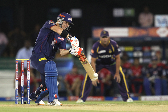 David Warner of Delhi Daredevils drives a delivery through to the boundary
