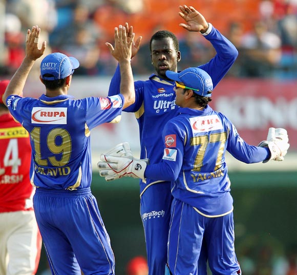 Kevon Cooper celebrates with team mates after getting the wicket of Shaun Marsh