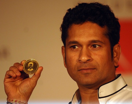 Sachin Tendulkar displays the gold coin at the launch