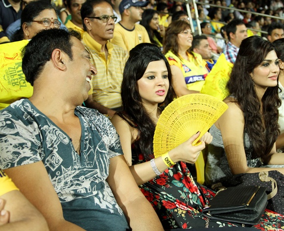 Vindoo Dara Singh (left) chats with Sakshi Dhoni during the IPL match between Chennai Super Kings and Mumbai Indians in Chennai on April 6, 2013