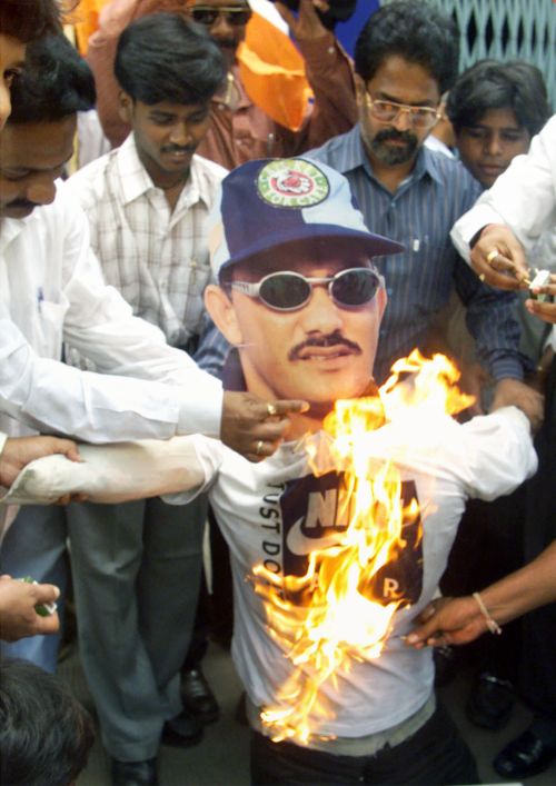 Protesters set fire to an effigy of Mohammad Azharuddin who was banned for life following the match-fixing scandal in 2000