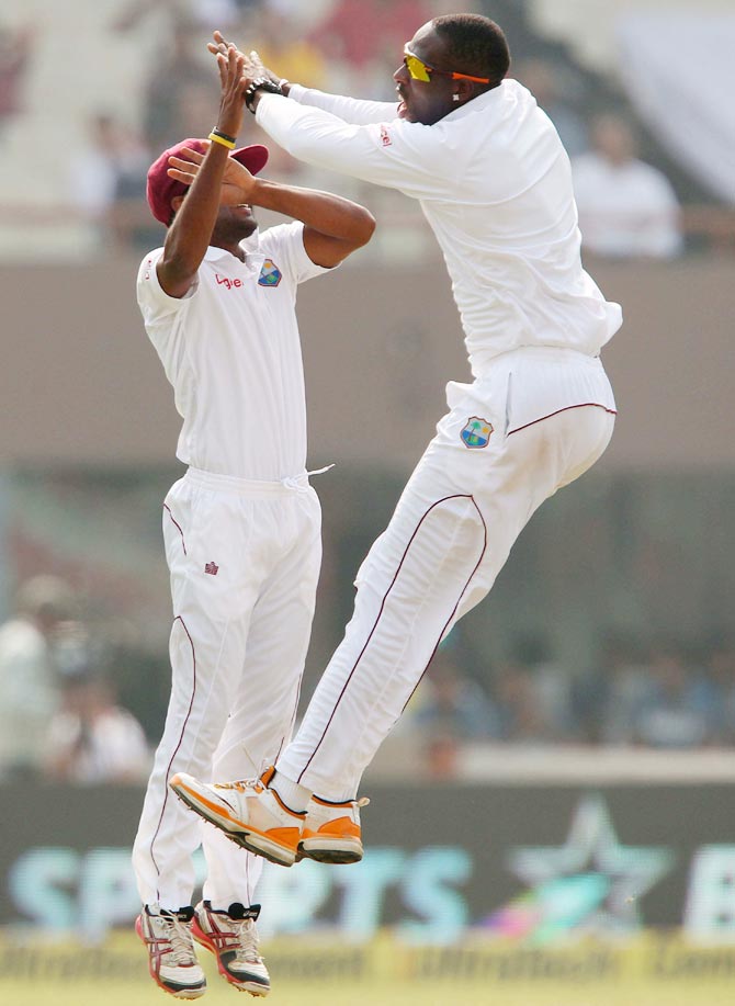 Shane Shillingford (right) celebrates the wicket of Murali Vijay