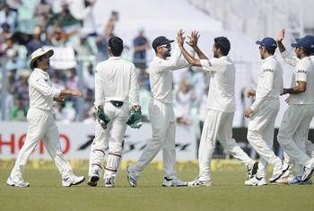 Indian players celebrate the fall of a West Indies wicket