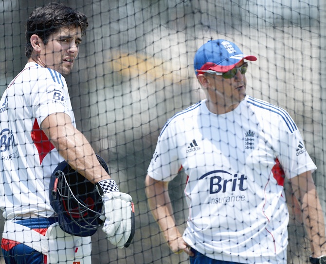 England captain Alastair Cook speaks with coach Andy Flower