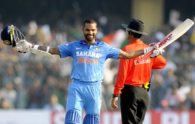 Shikhar Dhawan celebrates after completing his century