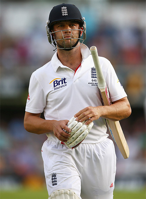 Jonathan Trott of England walks off the field after being dismissed by Mitchell Johnson in Brisbane