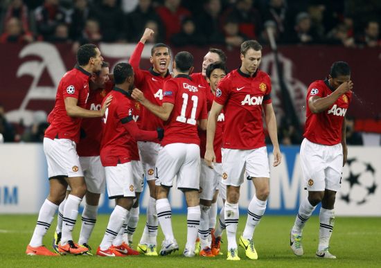Manchester United players celebrate after scoring a goal