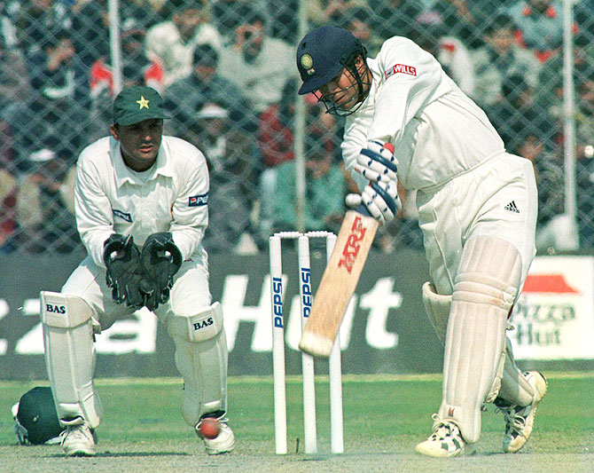 Sachin Tendulkar bats as Moin Khan watches in 1999