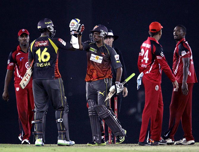 Thisara Perera (left) celebrates with Karan Sharma