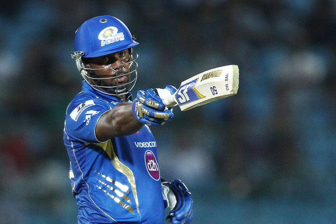 Dwayne Smith of Mumbai Indians raises his bat to the dug out after reaching his fifty