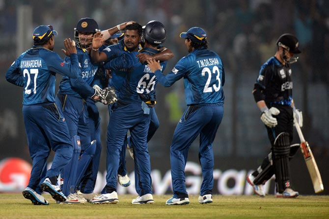 Rangana Herath (centre) celebrates with teammates after taking the wicket of Jimmy Neesham