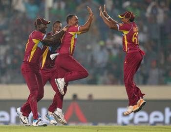 Samuel Badree of the West Indies is congratulated by Darren Sammy and his teammates after dismissing Shoaib Malik of Pakistan 