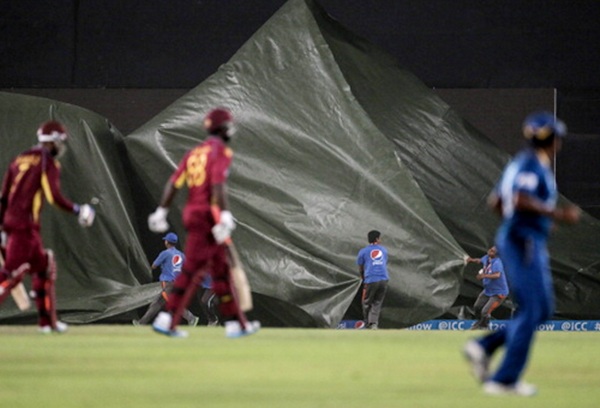 Groundstaff pull the covers on as a hailstorm approaches during the first sem-final between Sri Lanka and West Indies at the Sher-e-Bangla in Mirpur, Bangladesh 