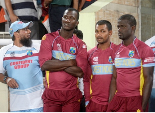 West Indies captain Darren Sammy (second left) and teammates look dejected after losing the semi-final match against Sri Lanka