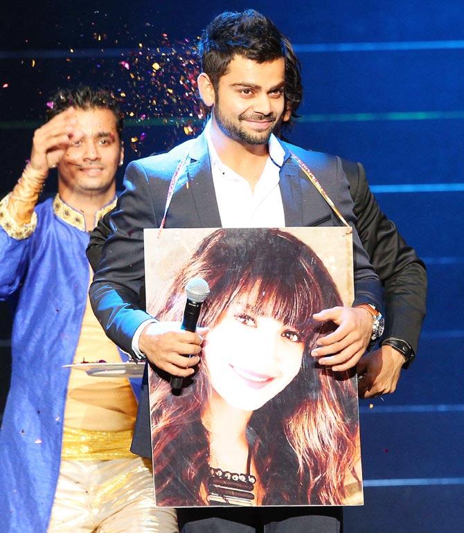 Virat Kohli with a poster of Anushka Sharma