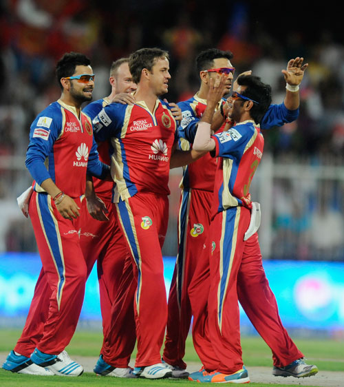 Albie Morkel celebrates taking a Delhi wicket with his RCB teammates