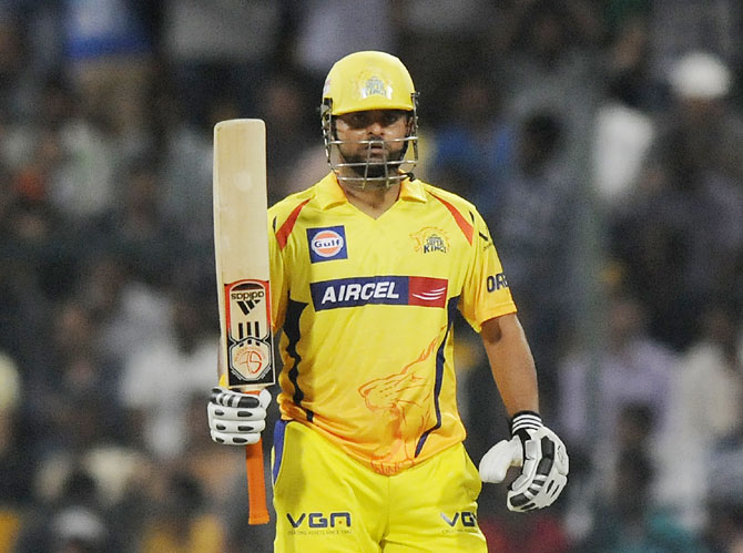Suresh Raina acknowledges the cheers from the crowd after getting to fifty