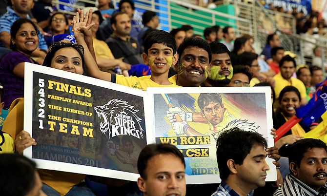 A fan holds up an interesting poster during the IPL match between Chennai Super Kings and Delhi Daredevils on Monday