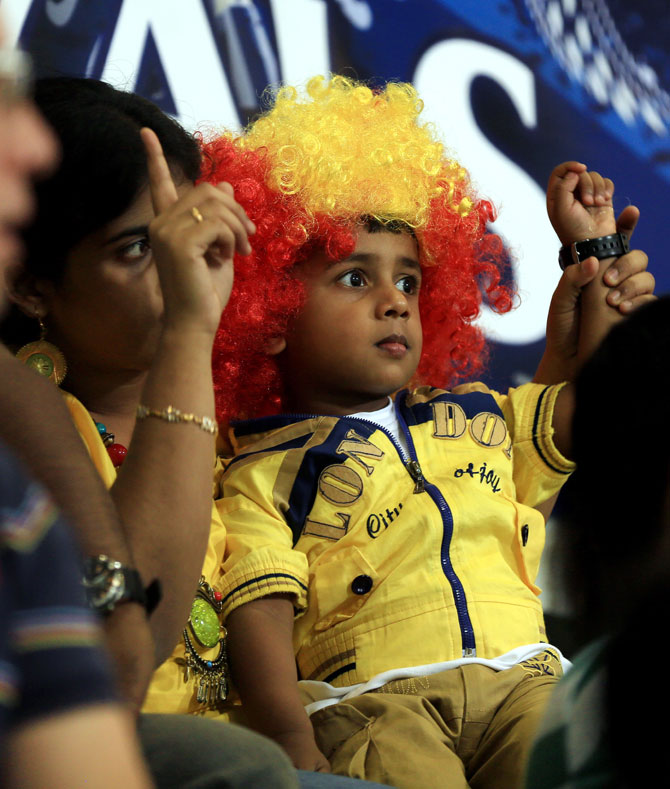 A kid and his mother enjoy the cricketing action on Monday