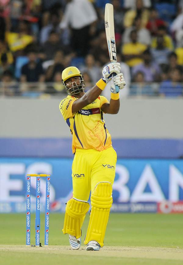 Chennai Super Kings' Dwayne Smith steps out to hit James Falkner for a six.
