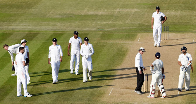 England bowler James Anderson (left) looks on as India batsman Ajinkya Rahane (second from right) talks to umpire Rod Tucker after play on Day 4