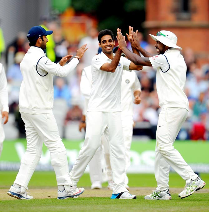 Bhuvneshwar Kumar (centre) is congratulated by team mates after he claimed the wicket of England batsman Chris Jordan
