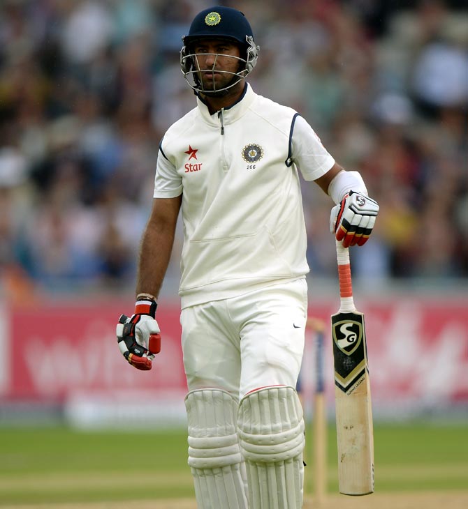 Cheteshwar Pujara of India leaves the field after being dismissed