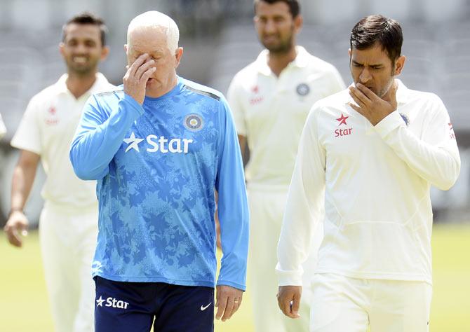 India's captain Mahendra Singh Dhoni (right) walks with coach Duncan Fletcher