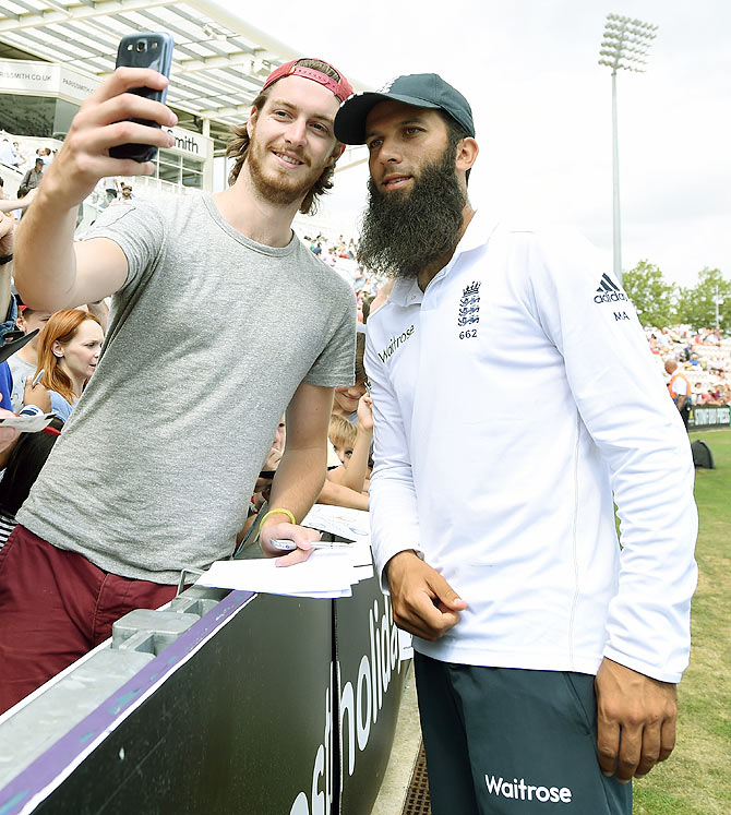 England bowler Moeen Ali poses for a selfie with a fan after day five of the 3rd Investec Test match between England and India at Ageas Bowl in Southampton on July 31