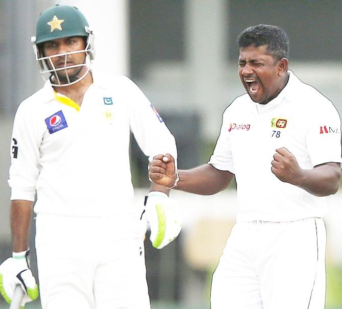 Sri Lanka's Rangana Herath, right, celebrates taking the wicket of Pakistan's Asad Shafiq (not pictured)