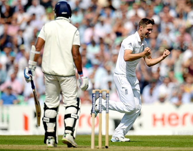 England's Chris Woakes (right) celebrates after dismissing India's Murali Vijay