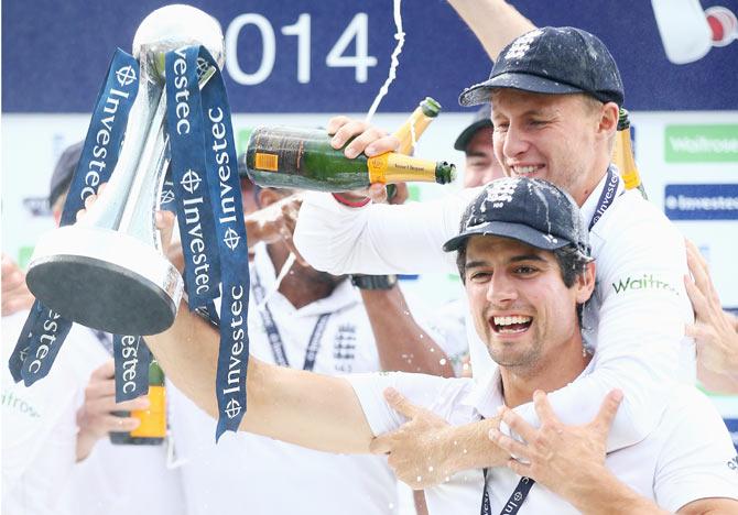 Captain Alastair Cook of England celebrates with Joe Root after defeating India at The Kia Oval in London to win the five-match Test series on Sunday