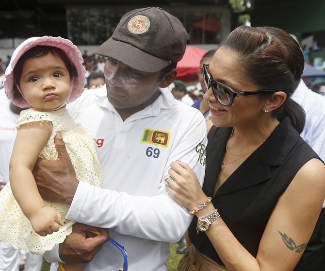 Sri Lanka's Mahela Jayawardene shares a moment with his daughter and wife Christina